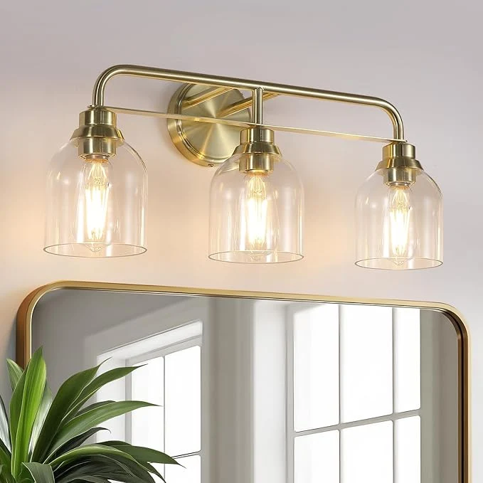 Artisan 3 Light Gold Vanity Lights for Bathroom Bathroom Light Fixtures Over Mirror with Clear Glass Shade Ceramic E26 Sockets Wall MountedAbout ThisOverview Responsible